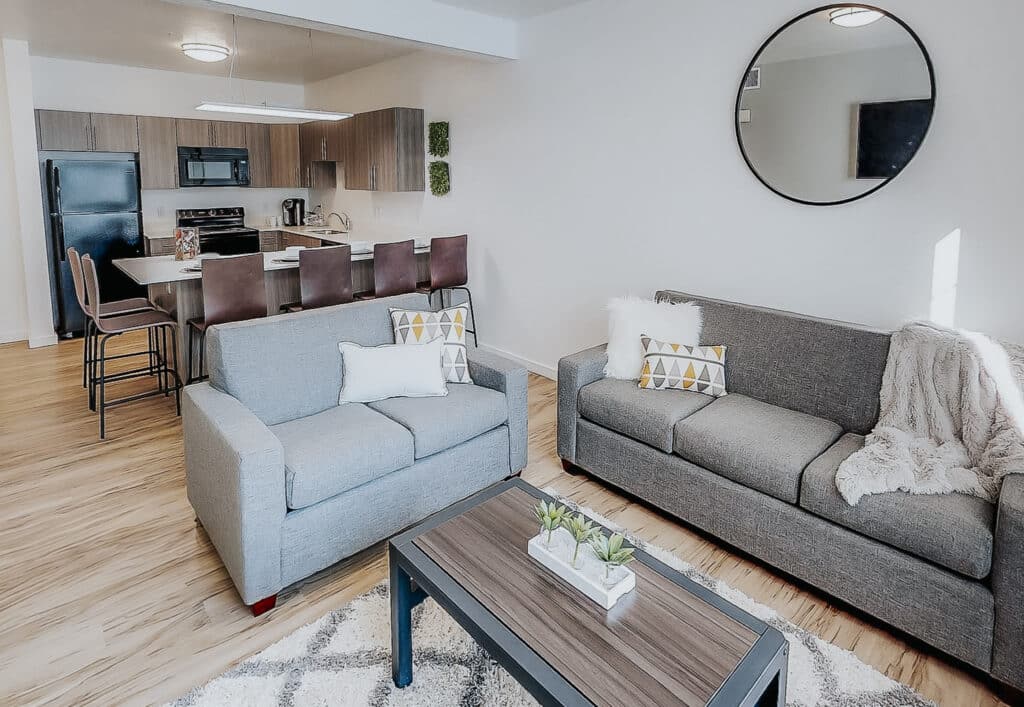 Furnished open-concept living room and kitchen in a Vintage at Tabernacle apartment