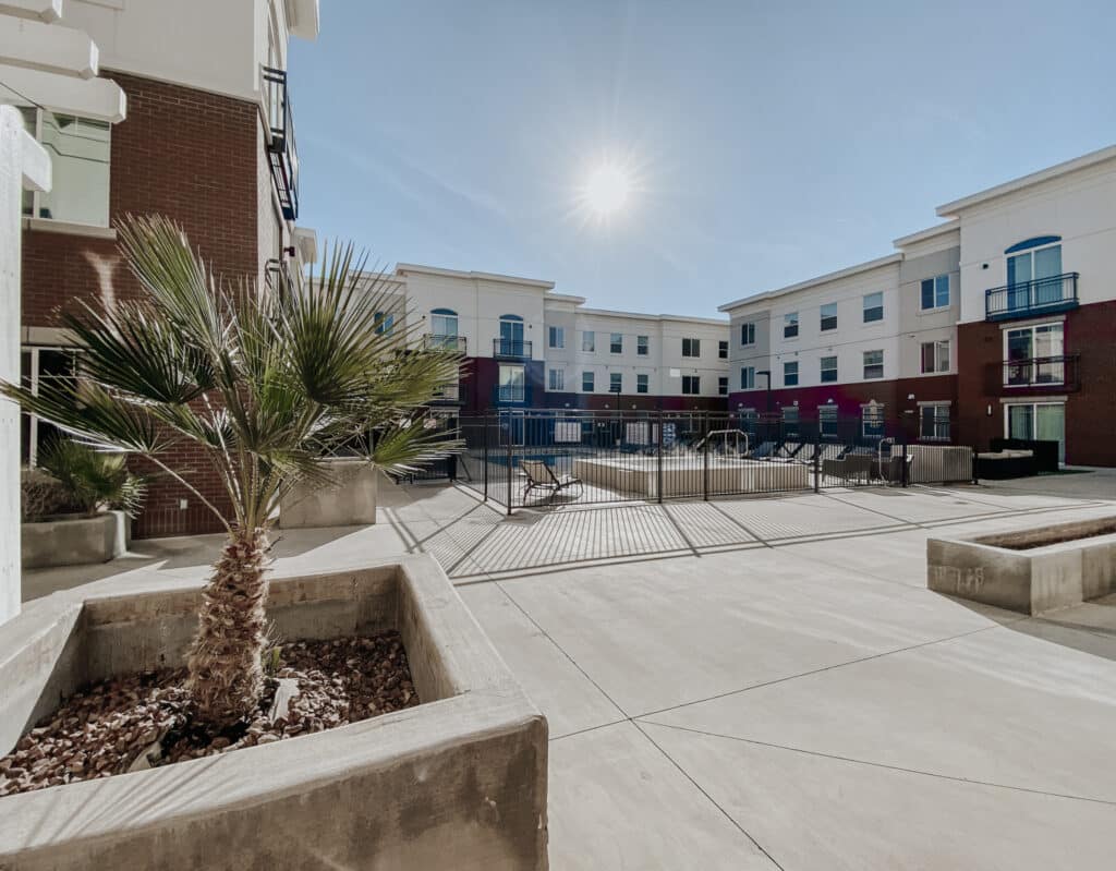 Outdoor courtyard with palm trees at Vintage at Tabernacle